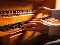 Man playing a church organ